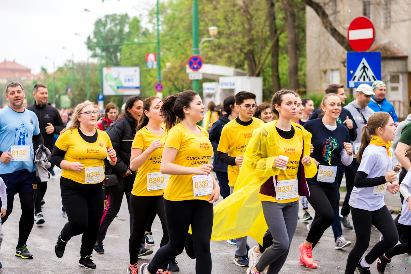 People running in a charity marathon on a city street.